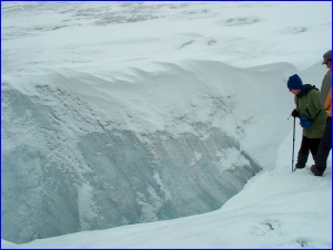 Teresa peering into a large millwell